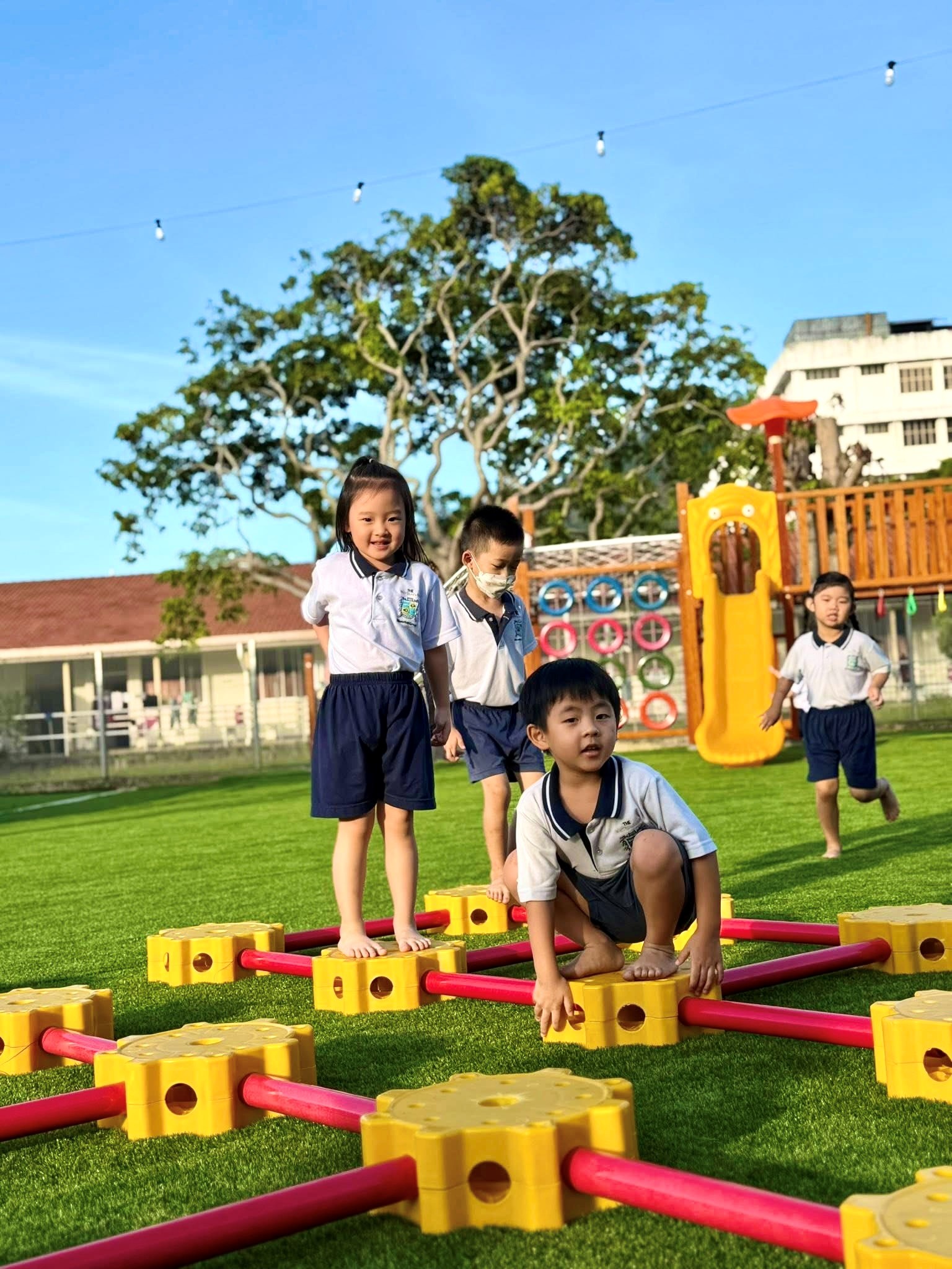 WhyteHouse children playing outdoors on the campus grounds