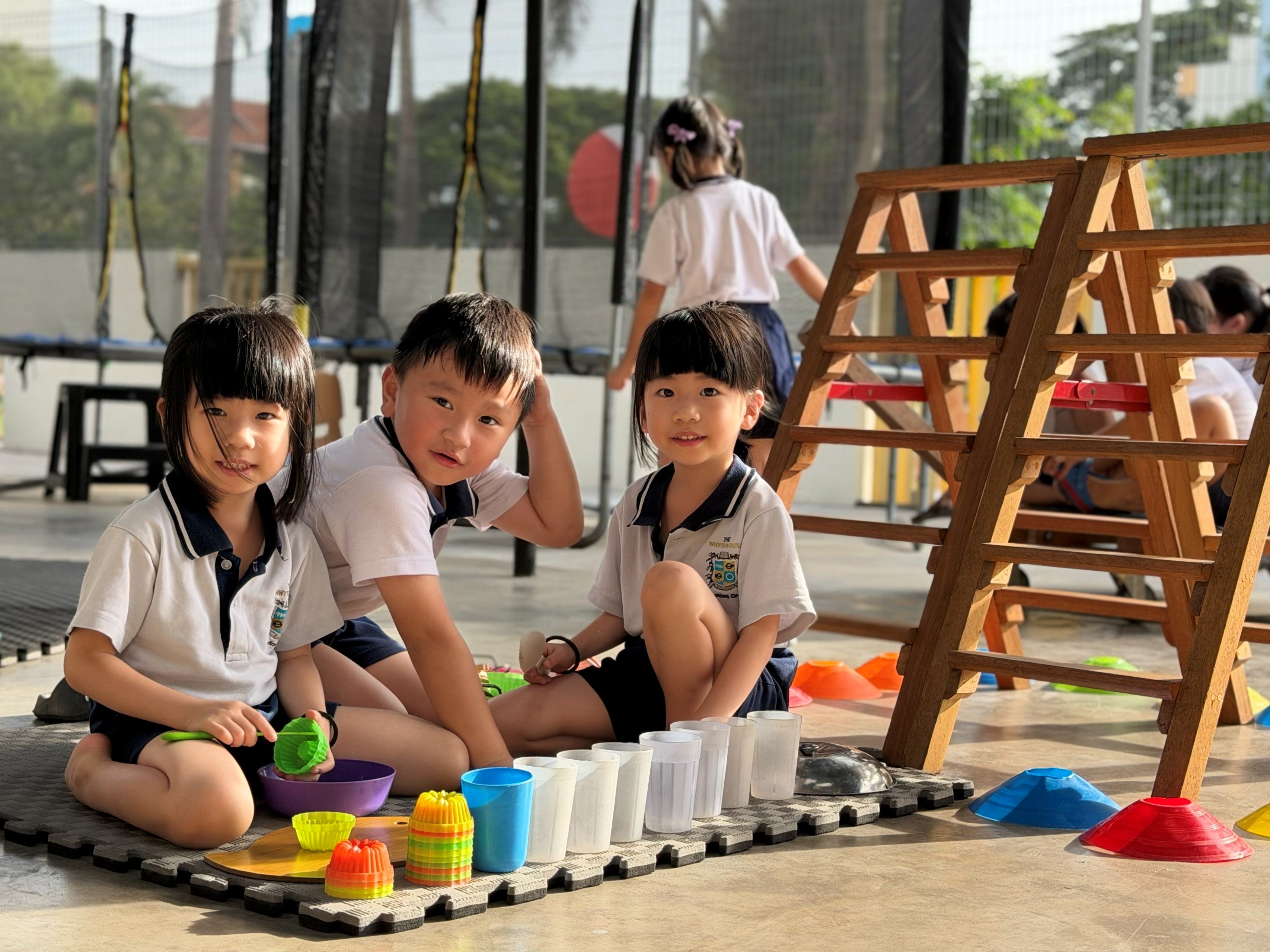Children climbing and jumping over the WE.PLAY tunnel outdoors